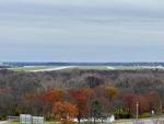 The runways of Wright-Patterson Air Force Base in the distance. The lower portion of the photo shows a bunch of trees, some of them still with late-fall colors.