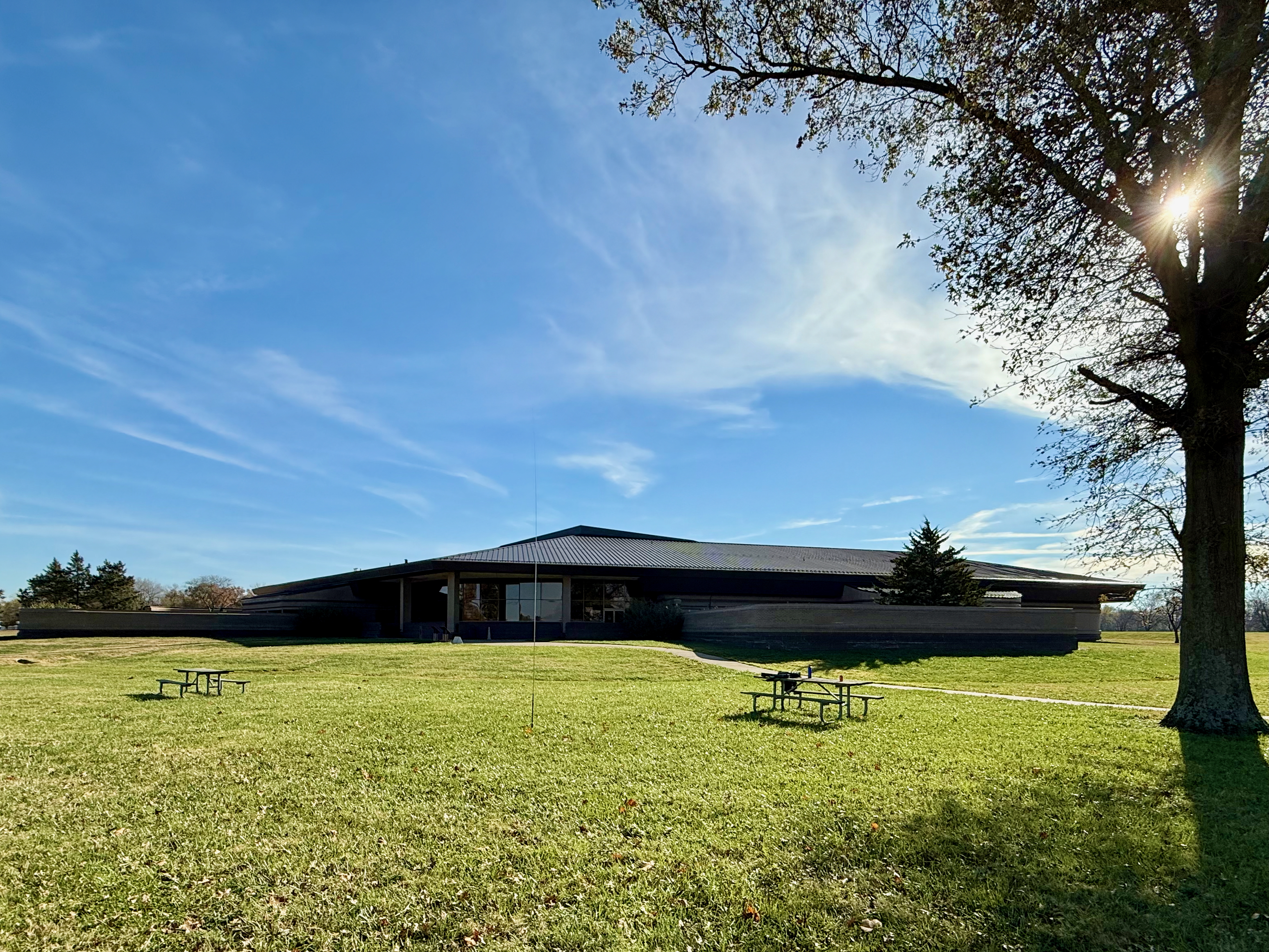 The back of the visitor's/interpretive center with the picnic bench I activated from in a grassy area.